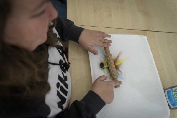 Freddie's Fibre Friends, Bowden Derra, Group activity with residents and staff layering felt sheets, promoting creativity and inclusion, @ThePark,